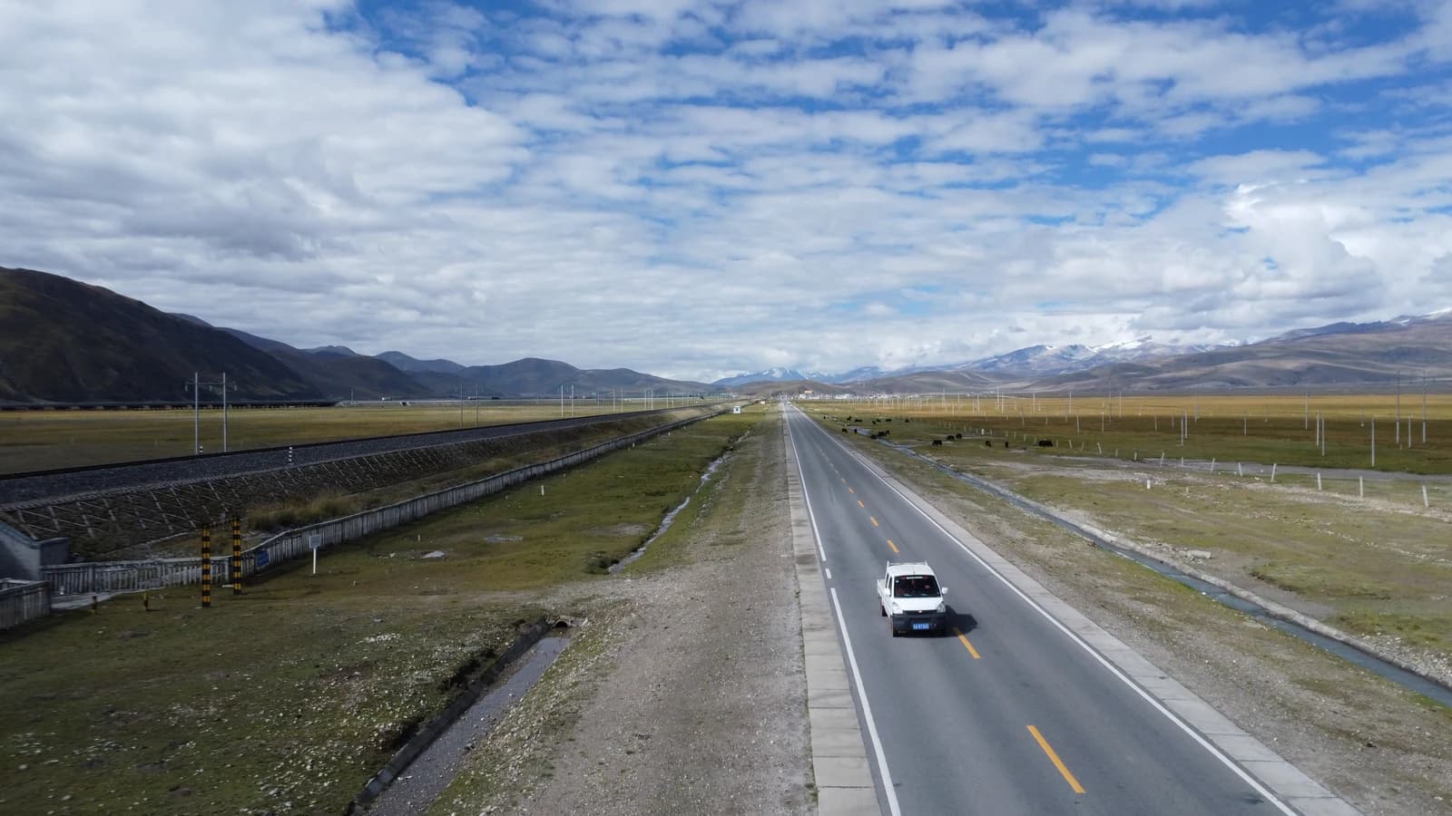 Aerial view of overland vehicle driving on plateau highway