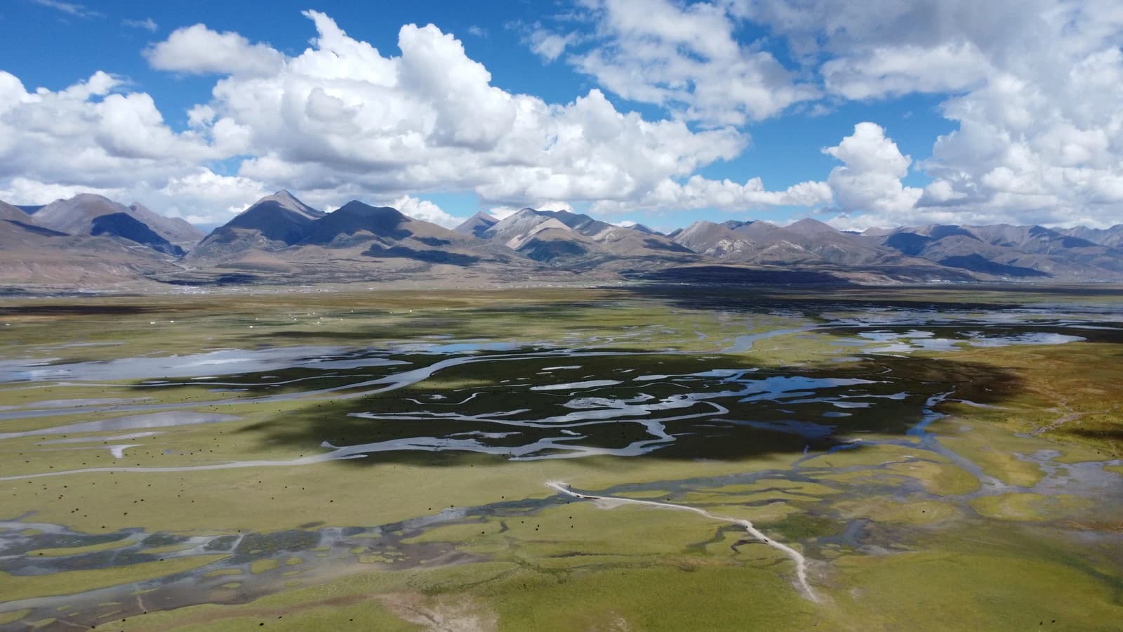 Aerial panorama of northern Tibet alpine wetlands reflecting clouds